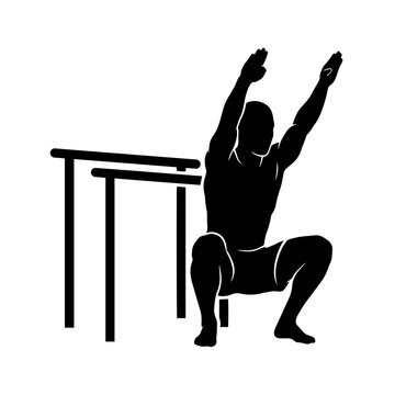 Muscular man doing squat exercise holding hands up near parallel bars