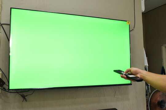 Concept of green screen. Hand young man on the couch and watching tv