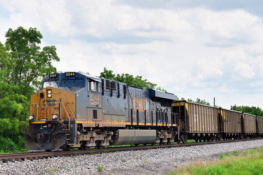  Led by a single CSX Transportation locomotive, a freight train, consisting of empty hopper cars, moves through rural east central Illinois.