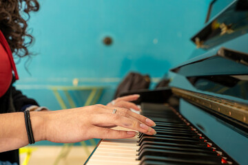 Musician's hands playing piano keys creating music © Fabian Vargas