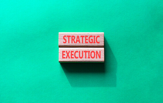 Strategic execution symbol. Concept word Strategic execution on wooden blocks. Beautiful green background. Business and Strategic execution concept. Copy space