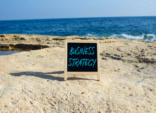 Business Strategy symbol. Blackboard with Concept words Business Strategy. Beautiful sea background. Business and Business Strategy concept. Copy space.