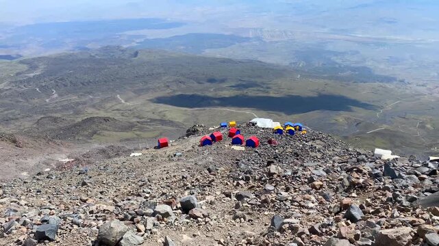High camp seen wide view from above on Mount Ararat in Turkey, showing summit tents on volcanic terrain, expedition staging, high-altitude logistics, route elevation, and mountaineering infrastructure