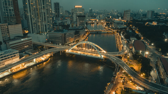 Binondo Intramuros Bridge aerial view over Pasig River at night with glowing city lights in Manila Philippines