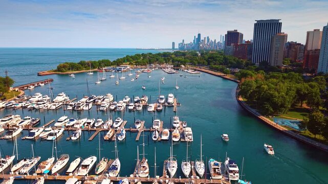 Diversity of boats and yachts at the berth in the large harbor. Lake Michigan shore in Chicago, Illinois, USA. Aerial view.