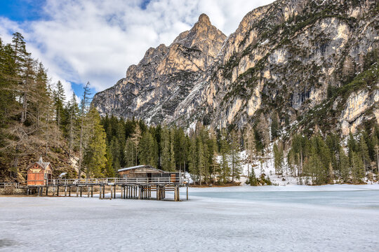 Lake Braies (Pragser See) in South Tyrol in winter, view of snowy mountain and Lake, Snow-covered Pragser Wildsee surrounded by steep, rocky mountains.