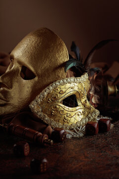 Golden vintage carnival masks with old wooden dices.