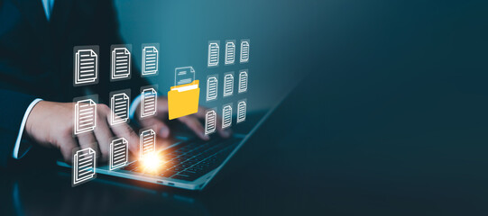 Business professional using a laptop to organize digital documents and files, illustrating secure...