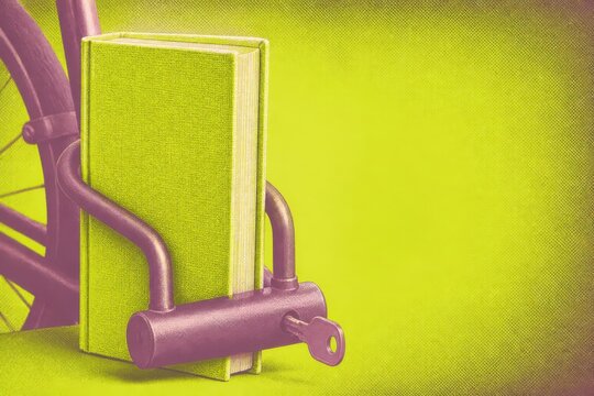 Protected textbook with bicycle lock on lime background