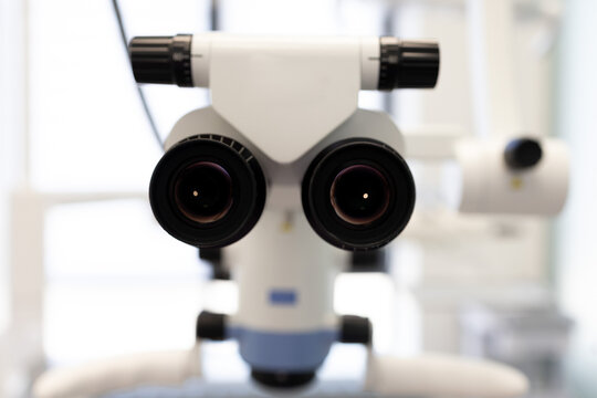Stereo microscope dominates the frame with sharp lenses