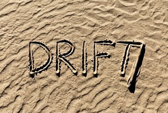Sandy Drift Typography Written in Textured Beach Sand with Shadows