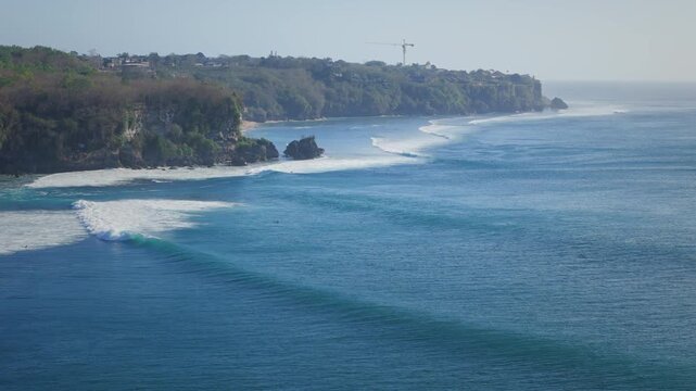 Aerial view of coastal landscape with ocean waves in ocean. Surfing and waves