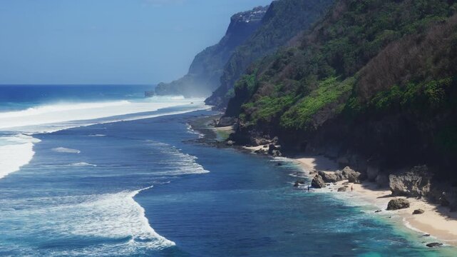Scenic landscape with cliff coastline, beach and blue ocean with waves. Drone view