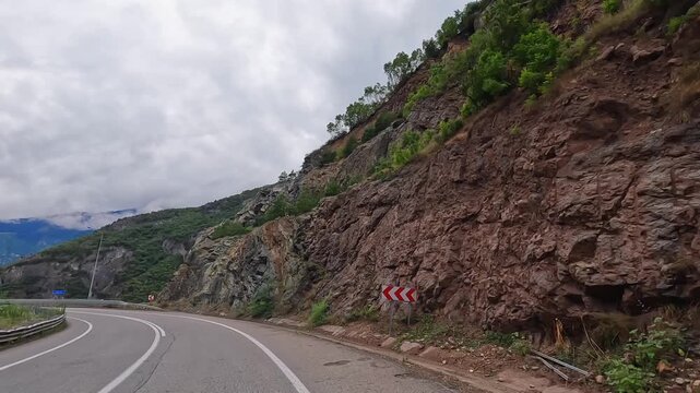Mountain highway runs through a rocky cut in wide road view in Turkey, showing overland travel, scenic driving, transport infrastructure, road engineering, regional mobility, and adventure tourism
