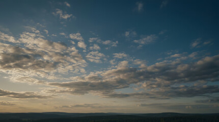Fototapeta premium Dramatic Sky with Cumulus Clouds over Distant Hills