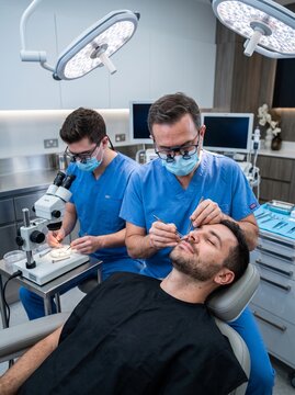 Professional medical team performing hair transplant surgery in a clinic