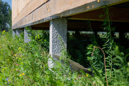A close-up of concrete piles on a country house under construction. Cottage foundation. 