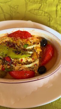 Traditional German style baked sheep cheese with tomatoes peppers onions olives and baguette, vertical video