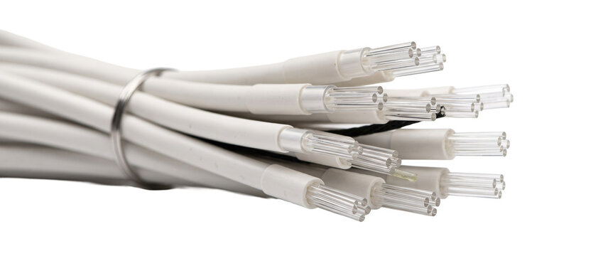 Fiber optic cable bundle white for high speed internet data transmission and telecommunications technology featuring transparent optical glass strands on black background for network infrastructure.