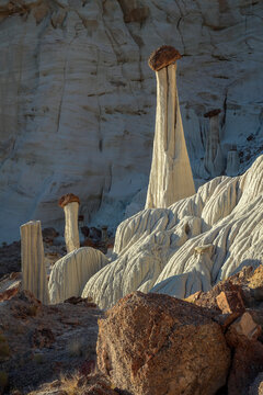 Beautiful vertical scenic view of unique natural sandstone hoodoo rock formations under evening sunlight