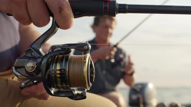 Two friends fishing on the lake from the boat