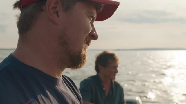 Two friends fishing on the lake from the boat