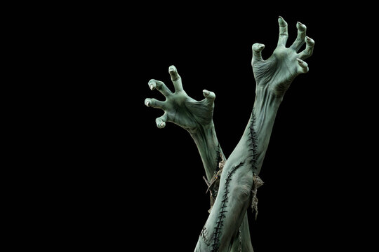 Two decayed zombie hands reaching upward with claw-like nails, Halloween horror portrait
