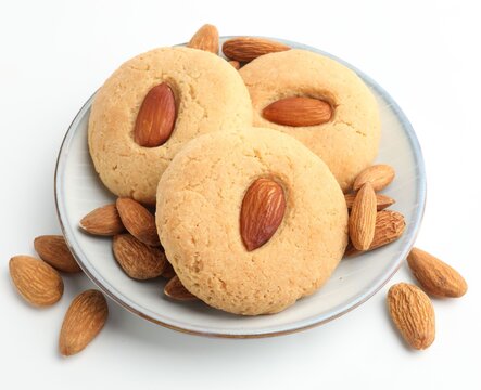 Tasty almond cookies and nuts isolated on white