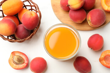 Apricot juice in glass and fresh fruits on white table, flat lay © New Africa