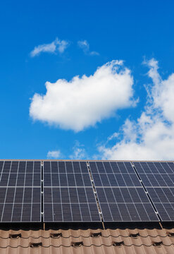 Installing solar panels on a house roof. Selective focus.