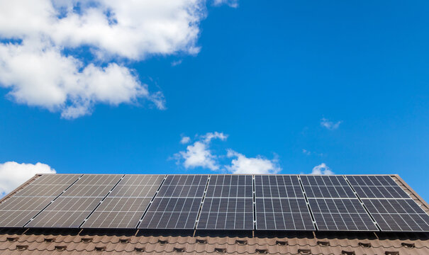 Installing solar panels on a house roof. Selective focus.