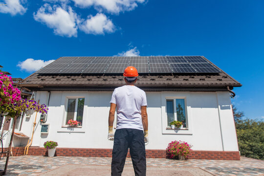Installing solar panels on a house roof. Selective focus.