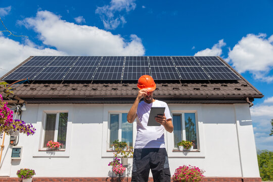 Installing solar panels on a house roof. Selective focus.