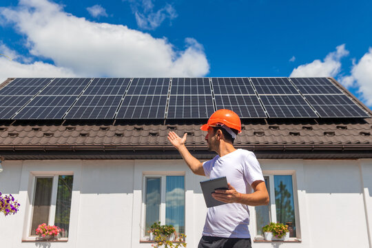 Installing solar panels on a house roof. Selective focus.