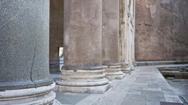 Historic stone columns and worn bases with soft shallow focus highlighting foreground texture at agrippa pantheon rome plaza; background backplate copyspace calm.