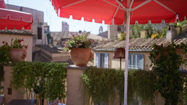 Rooftop terrace with red umbrella, terracotta pots and hanging greenery, soft defocused bokeh outdoor; background backplate copyspace calm.