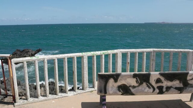 Empty bench on coastal promenade with ocean view Candas Asturias Spain