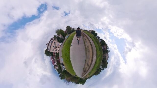 Cycling on a path with a 360 camera creating a tiny planet view