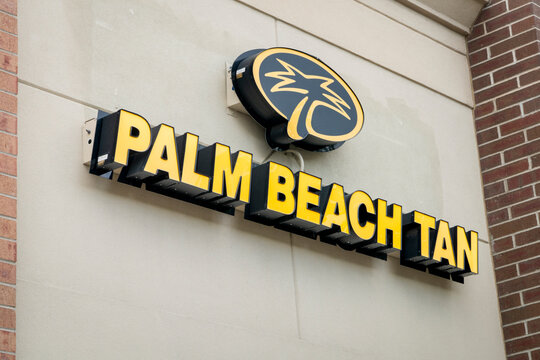 Fort Collins, CO, USA - August 25, 2026: Palm Beach Tan sign and logo on the facade of a local tanning salon in Fort Collins, Colorado. Indoor tanning and beauty services business.