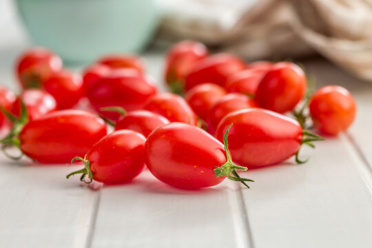 Fresh Red Cherry and Plum Tomatoes on Wooden Table for Cooking and Salad Recipes