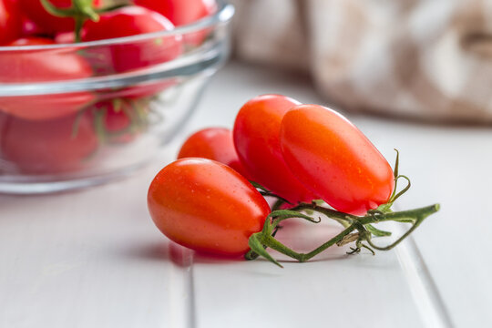 Fresh Red Cherry and Plum Tomatoes on Wooden Table for Cooking and Salad Recipes