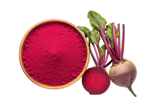 A nice arrangement top down view of a nice and perfect wooden bowl of cherry red beetroot powder with fresh and healthy whole and sliced beets isolated on transparent background
