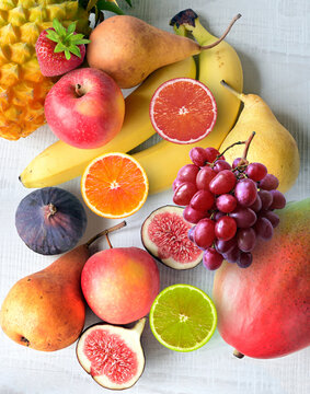 Fresh fruits mixed. Tasty fruits background, citruses, apples, grapes.