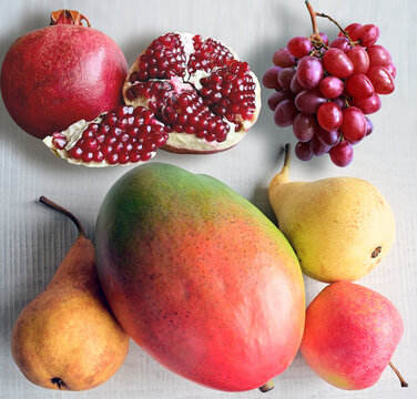 Fresh fruits mixed. Tasty fruits background, citruses, apples, grapes.