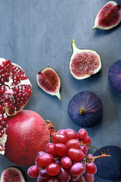 Fresh fruits mixed. Tasty fruits background, fig, grapes, pomegranate.