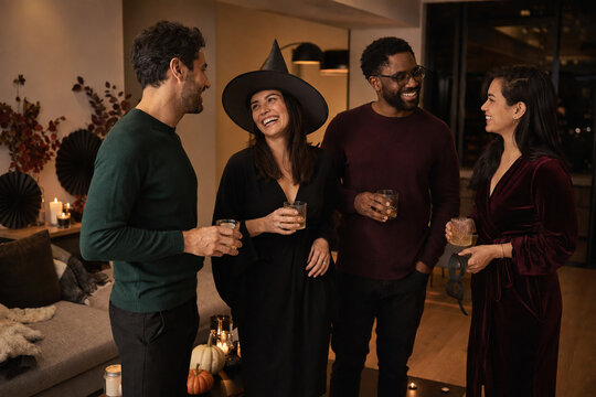 Friends enjoying an elegant Halloween party at home