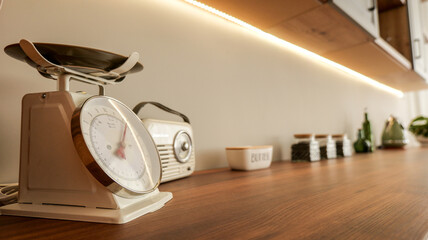 Vintage kitchen scale and retro radio on a wooden countertop
