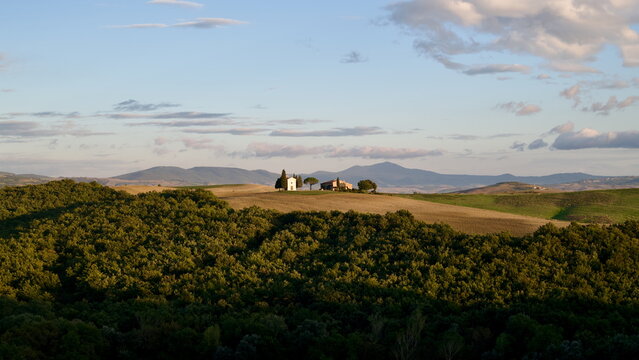 Historic Vitaleta Chapel surrounded by rolling hills in Val d'Orcia Tuscany Italy for travel website