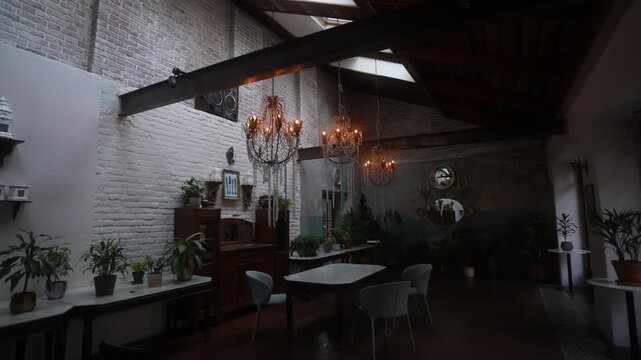 Loft dining interior with illuminated crystal chandeliers hanging from exposed wooden beams and skylights, with interior, loft, chandelier, brick detail, showing beam, skylight, wood, marble context