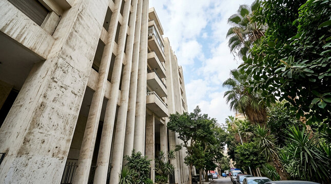 Low angle view of modernist concrete building facade with tall vertical columns